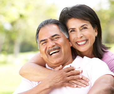 Photo of a man and woman smiling for a picture. Photo of a man and woman smiling for a picture.